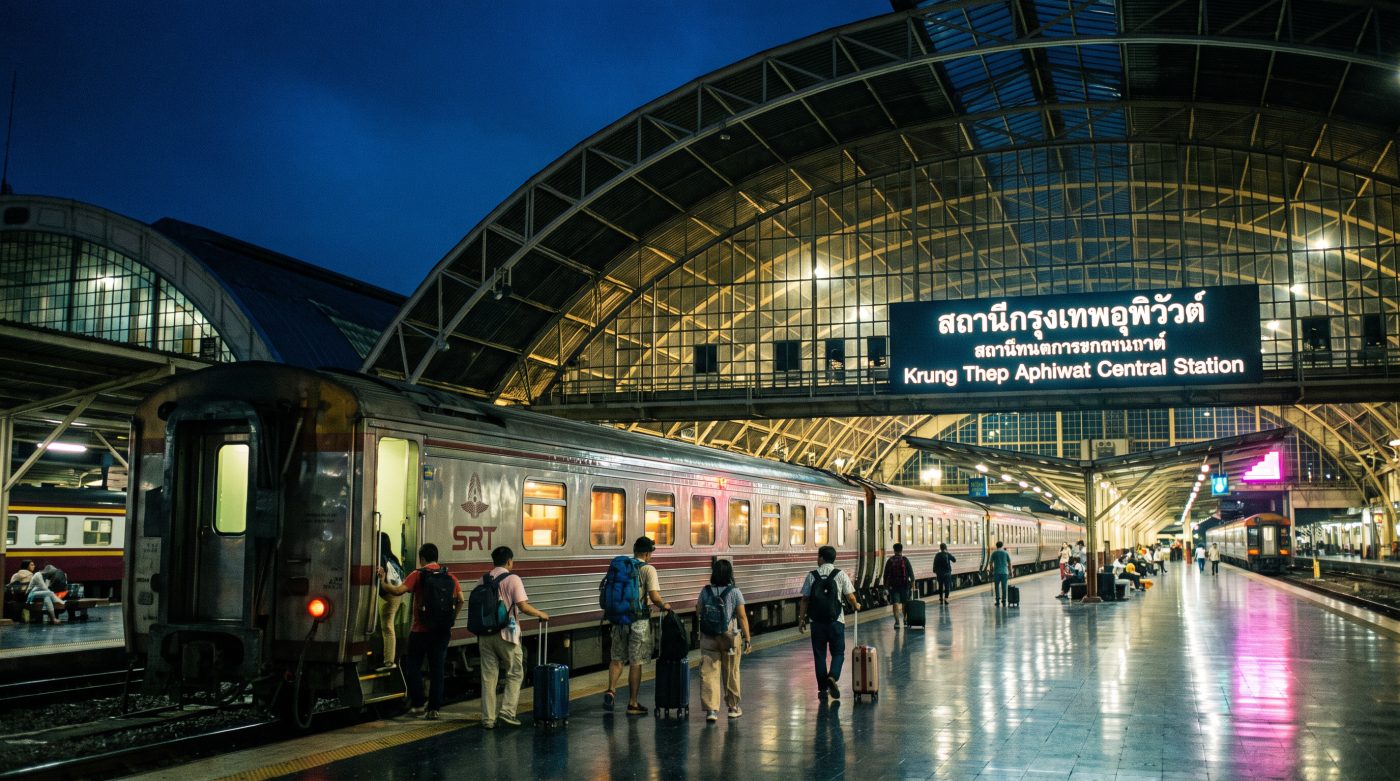 Krung Thep Aphiwat station at night with an overnight sleeper train at the platform